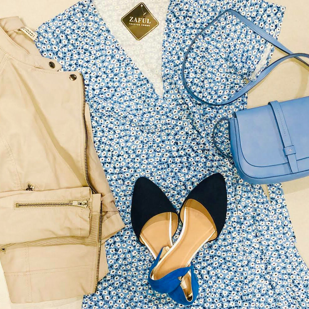 floral dress with matching blue purse, beige jacket and blue flats