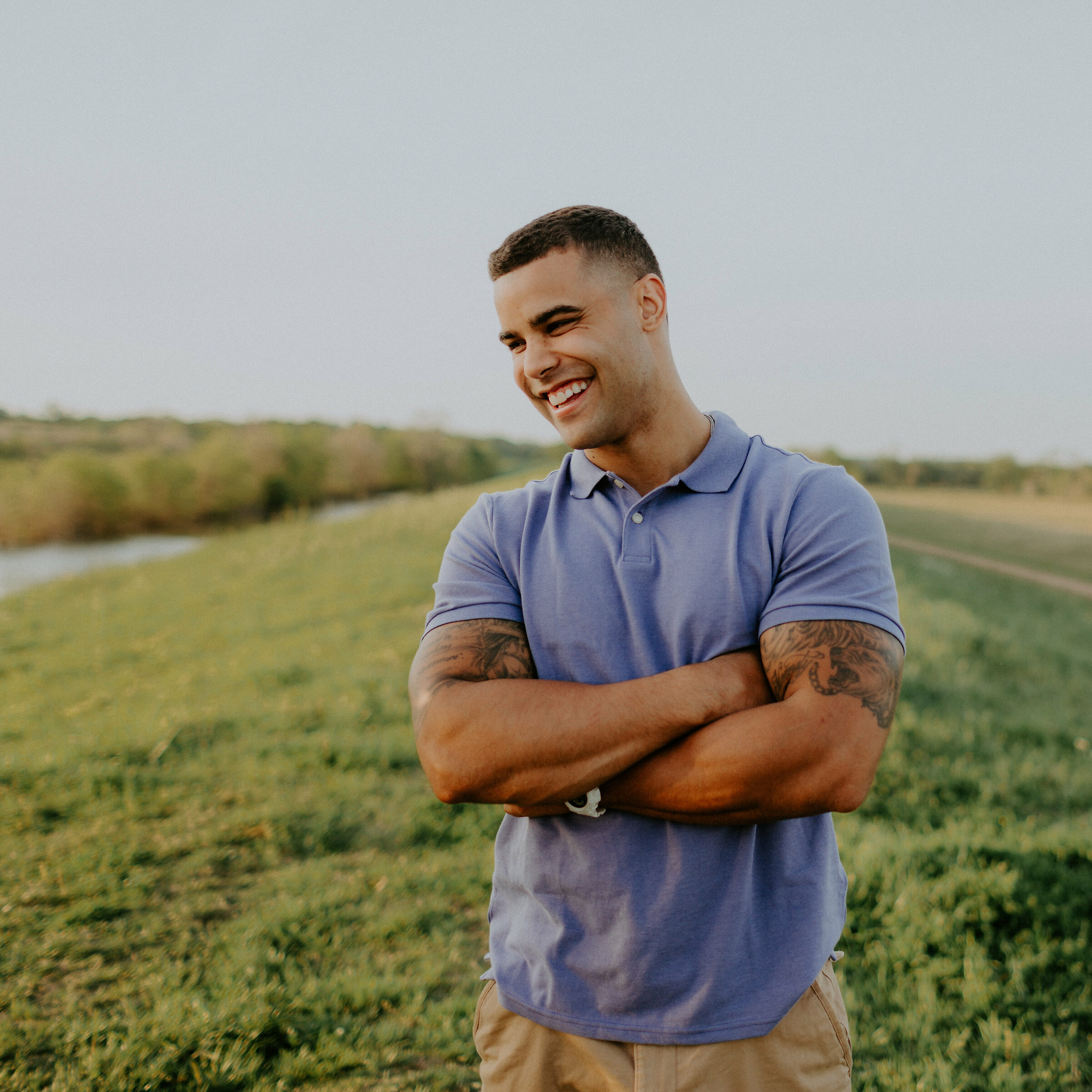 man standing outside with arms folded