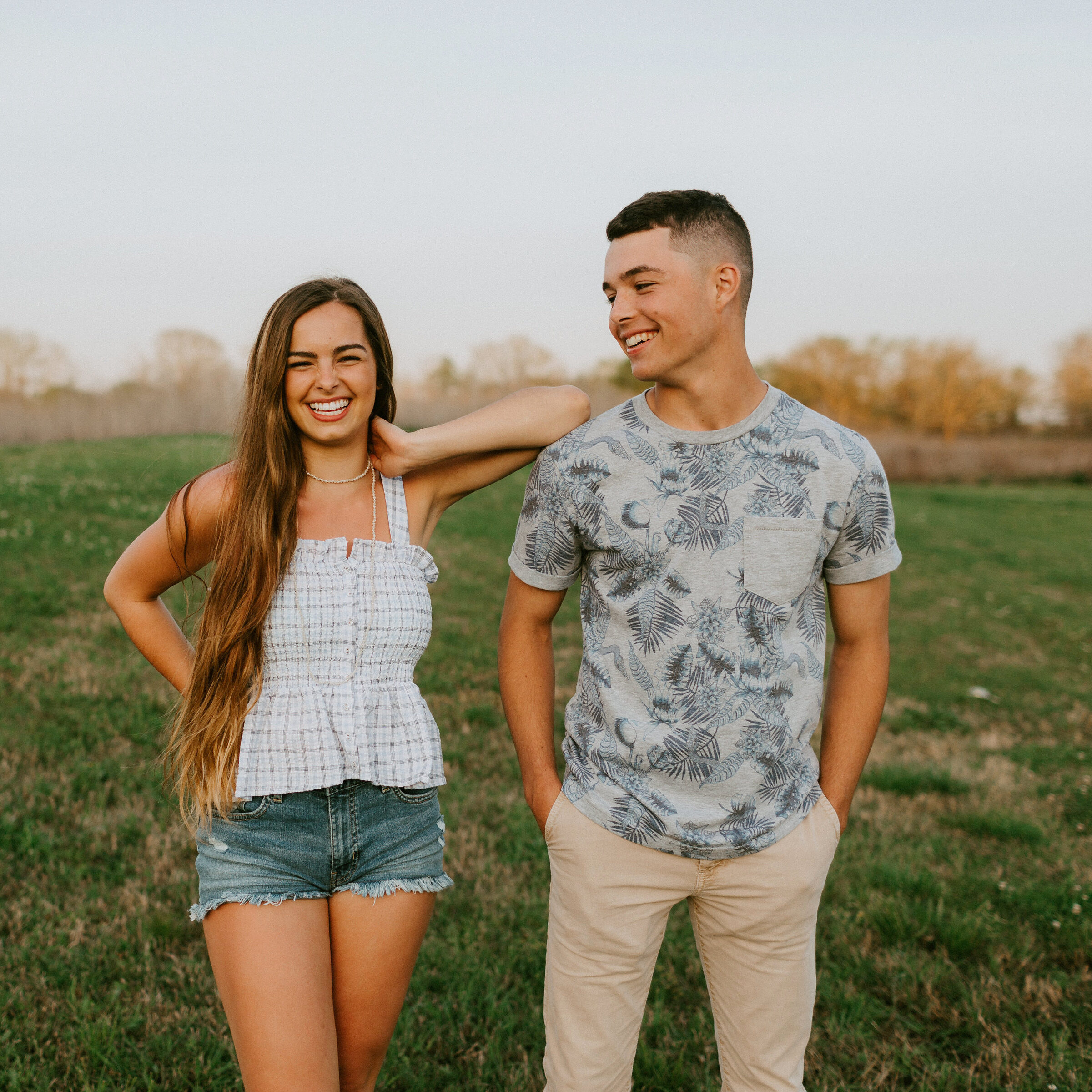 a man and woman standing outside 