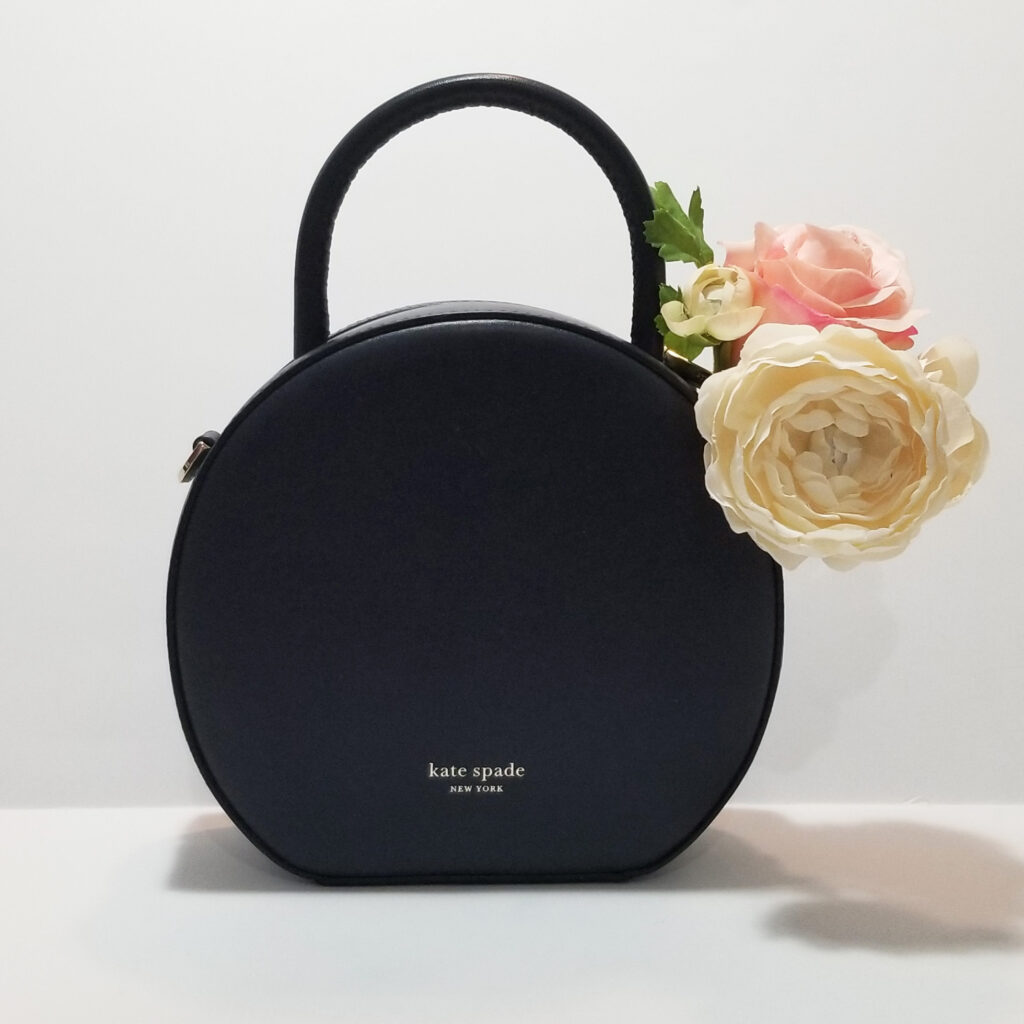 Round hand bag with flower accent