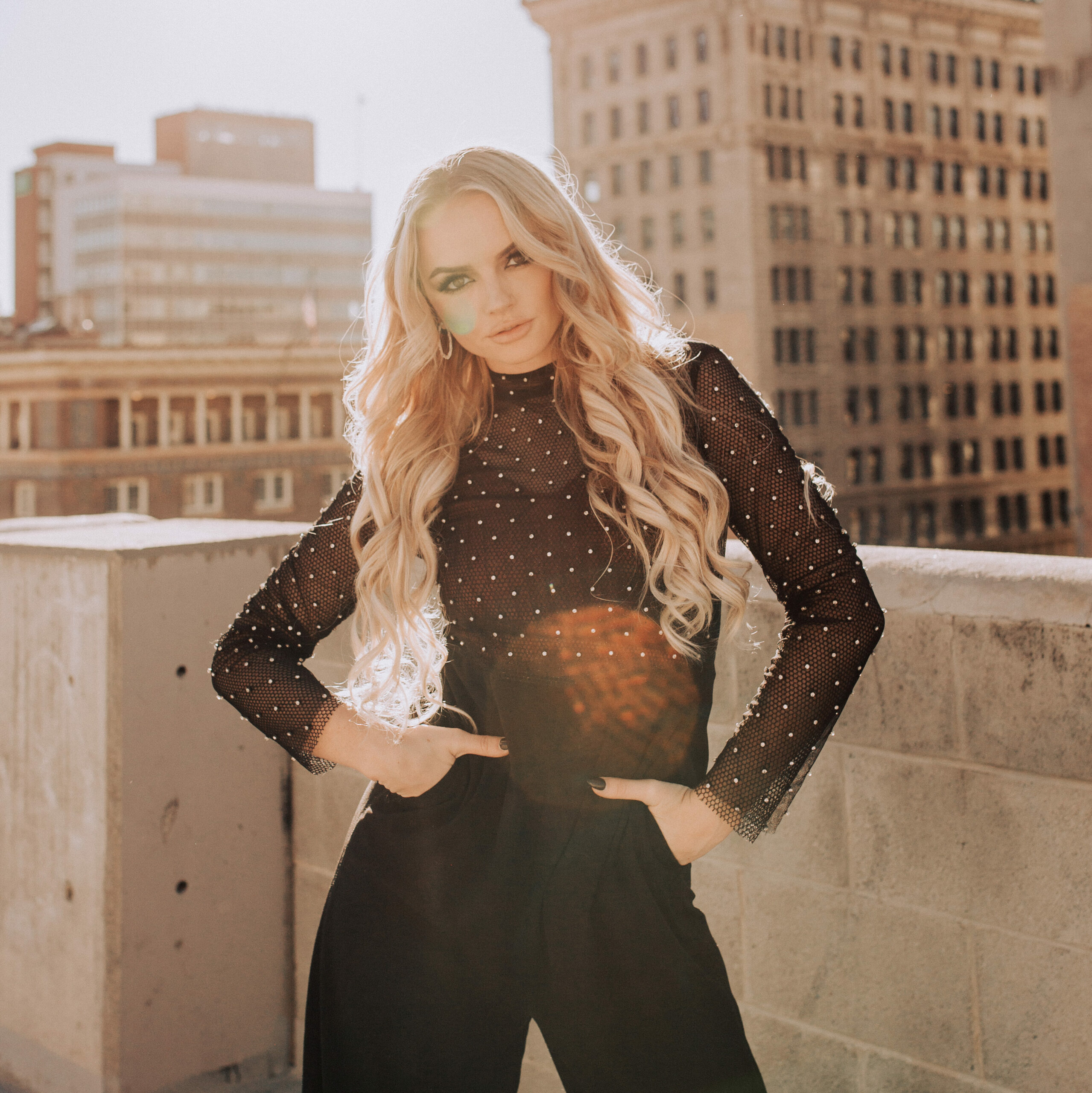 girl on rooftop in the city wearing a jumpsuit from uptown cheapskate